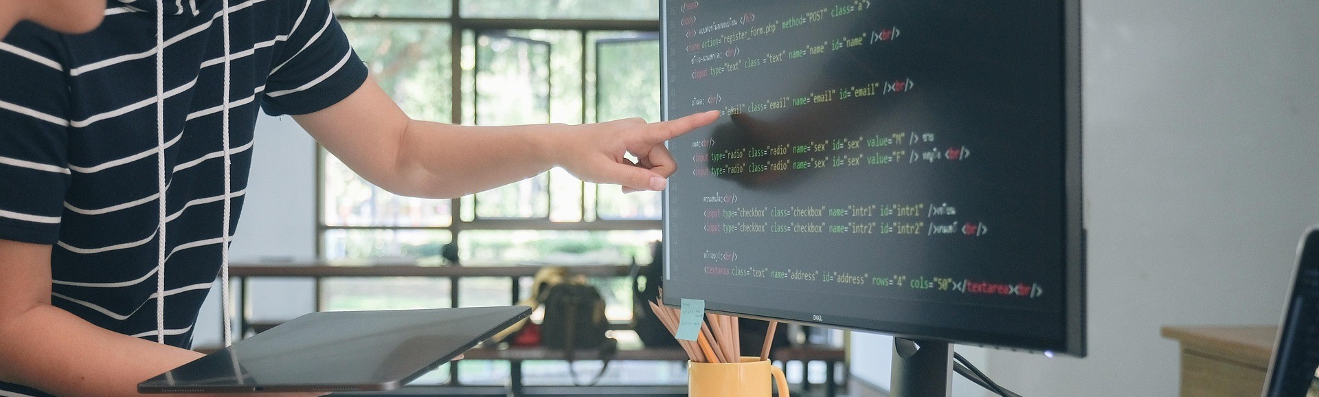 A professional website development banner featuring a developer working on a laptop with a website UI, coding icons, and bold text saying "Website Development – Custom, fast, secure, and scalable web development solutions"